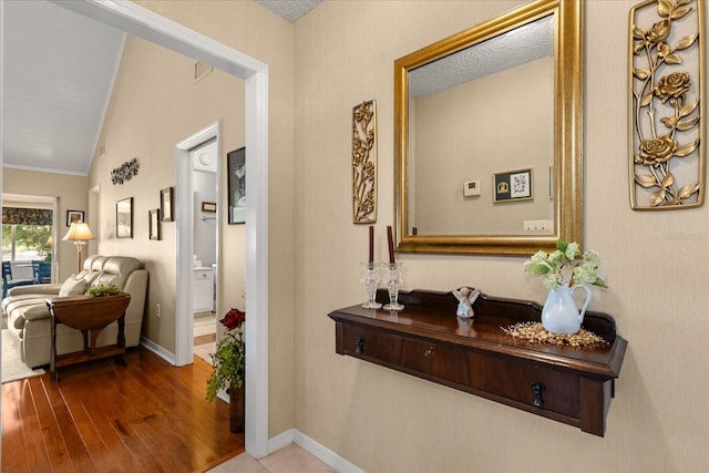 1146 Villa Ln Unit 101, Apopka, FL 32712 - corridor featuring wood finished floors, vaulted ceiling, and baseboards