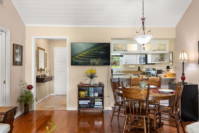 1146 Villa Ln Unit 101, Apopka, FL 32712 - dining room with wood-type flooring, crown molding, and baseboards