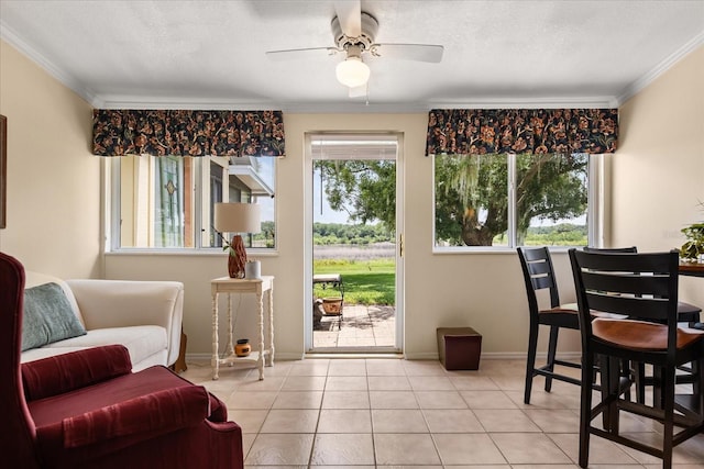 1146 Villa Ln Unit 101, Apopka, FL 32712 - living room featuring a ceiling fan, crown molding, light tile patterned flooring, and baseboards