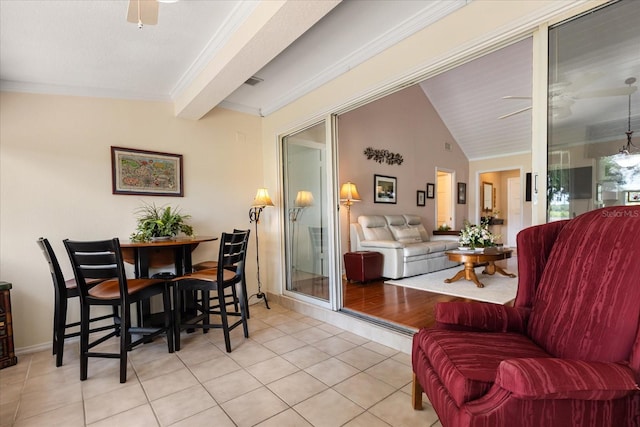 1146 Villa Ln Unit 101, Apopka, FL 32712 - dining room with light tile patterned floors, a ceiling fan, ornamental molding, lofted ceiling, and baseboards