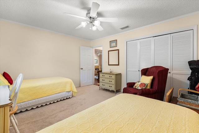 1146 Villa Ln Unit 101, Apopka, FL 32712 - carpeted bedroom featuring a closet, a textured ceiling, ornamental molding, and ceiling fan