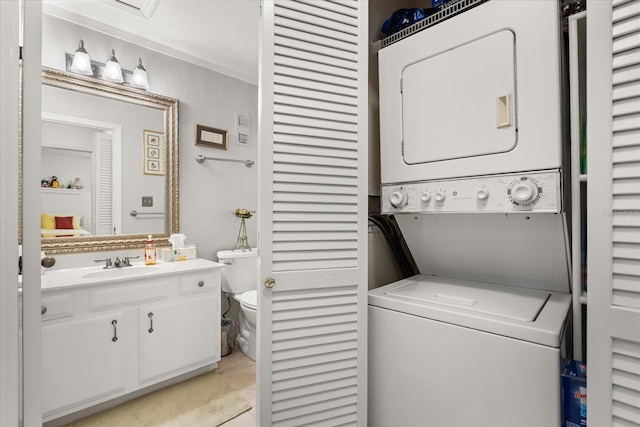 1146 Villa Ln Unit 101, Apopka, FL 32712 - laundry area with stacked washing machine and dryer and ornamental molding