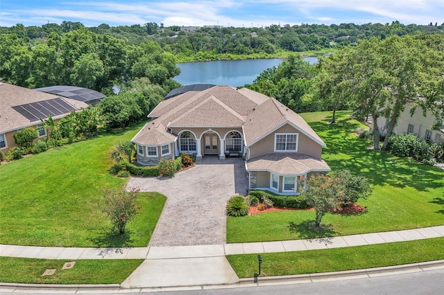 1017 Parkside Pointe Blvd, Apopka, FL 32712 - view of front facade featuring decorative driveway, a water view, a front yard, and a porch