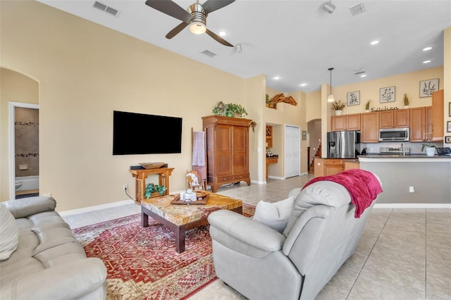 1017 Parkside Pointe Blvd, Apopka, FL 32712 - living area with arched walkways, ceiling fan, light tile patterned floors, baseboards, and recessed lighting