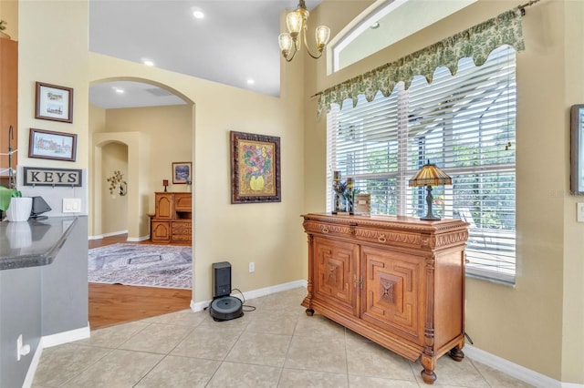 1017 Parkside Pointe Blvd, Apopka, FL 32712 - hall featuring arched walkways, baseboards, light tile patterned floors, and recessed lighting