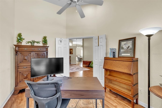1017 Parkside Pointe Blvd, Apopka, FL 32712 - office space featuring a ceiling fan, light wood finished floors, a towering ceiling, and baseboards