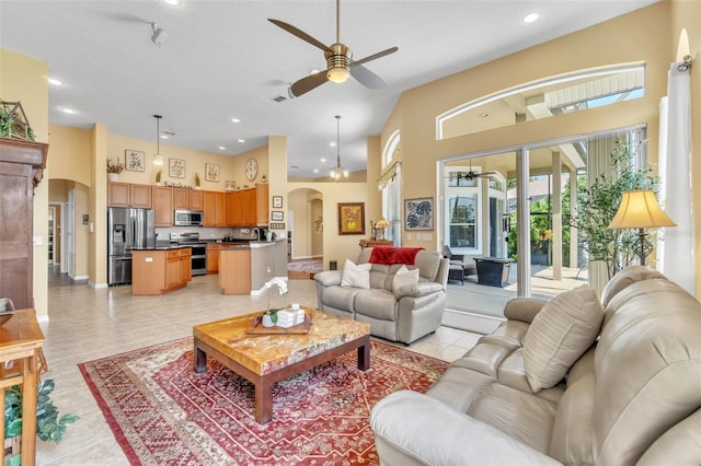 1017 Parkside Pointe Blvd, Apopka, FL 32712 - living room with arched walkways, a ceiling fan, a high ceiling, recessed lighting, and light tile patterned floors