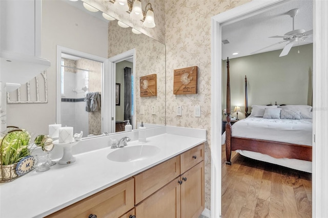 1017 Parkside Pointe Blvd, Apopka, FL 32712 - full bathroom featuring vanity, wallpapered walls, ensuite bath, a ceiling fan, and tiled shower