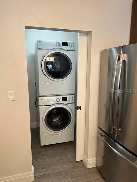 14501 Grove Resort Ave Unit 2129, Winter Garden, FL 34787 - laundry room with estacked washer and dryer, baseboards, and wood finished floors