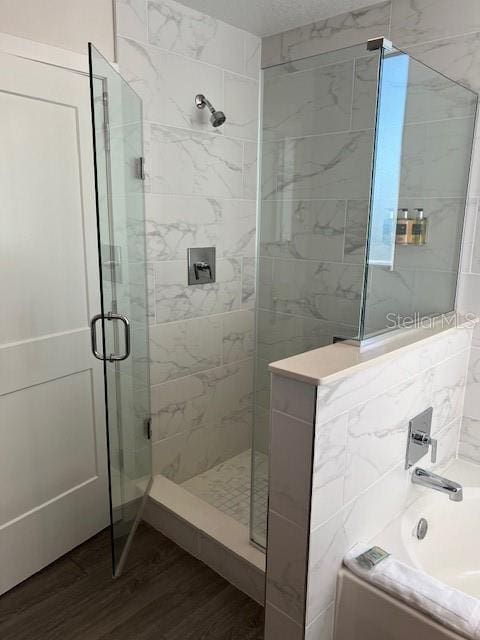 14501 Grove Resort Ave Unit 2129, Winter Garden, FL 34787 - bathroom with wood finished floors, a stall shower, and a garden tub