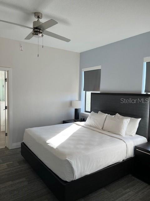 14501 Grove Resort Ave Unit 2129, Winter Garden, FL 34787 - bedroom featuring baseboards, ceiling fan, and dark wood-style flooring