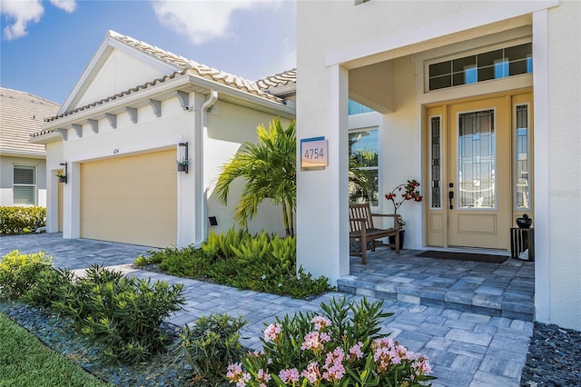 4754 Manning Ct, Sarasota, FL 34240 - entrance to property featuring stucco siding, a garage, and driveway