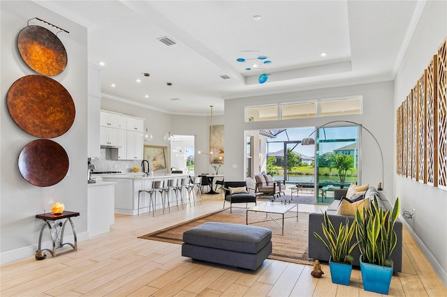 4754 Manning Ct, Sarasota, FL 34240 - living area featuring light wood-style flooring, recessed lighting, crown molding, and baseboards