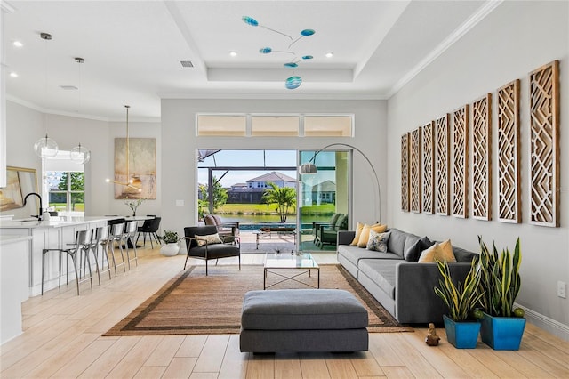 4754 Manning Ct, Sarasota, FL 34240 - living room featuring light wood finished floors, a tray ceiling, ornamental molding, and recessed lighting
