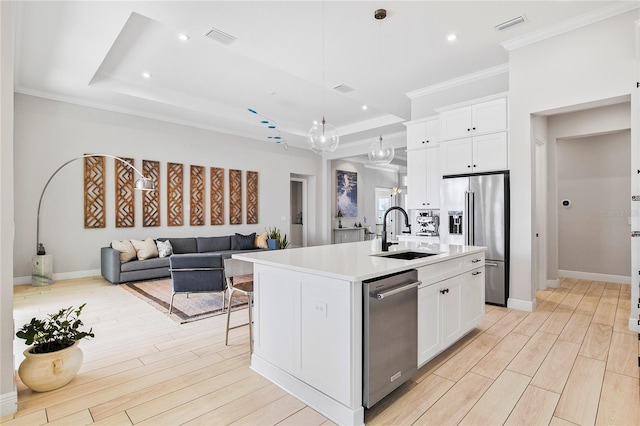 4754 Manning Ct, Sarasota, FL 34240 - kitchen with appliances with stainless steel finishes, a sink, crown molding, open floor plan, and light countertops