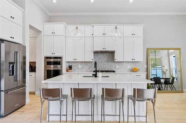 4754 Manning Ct, Sarasota, FL 34240 - kitchen featuring stainless steel appliances, light wood finished floors, ornamental molding, light countertops, and backsplash