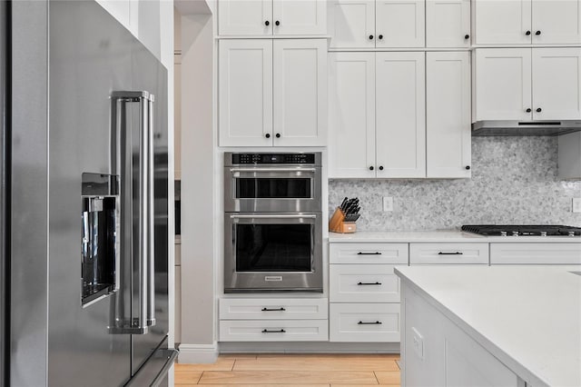 4754 Manning Ct, Sarasota, FL 34240 - kitchen with stainless steel appliances, light countertops, and tasteful backsplash