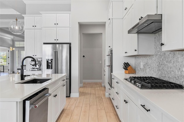 4754 Manning Ct, Sarasota, FL 34240 - kitchen featuring appliances with stainless steel finishes, a sink, extractor fan, baseboards, and backsplash