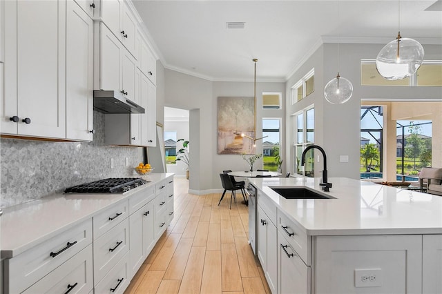 4754 Manning Ct, Sarasota, FL 34240 - kitchen with a sink, under cabinet range hood, stainless steel appliances, light countertops, and baseboards