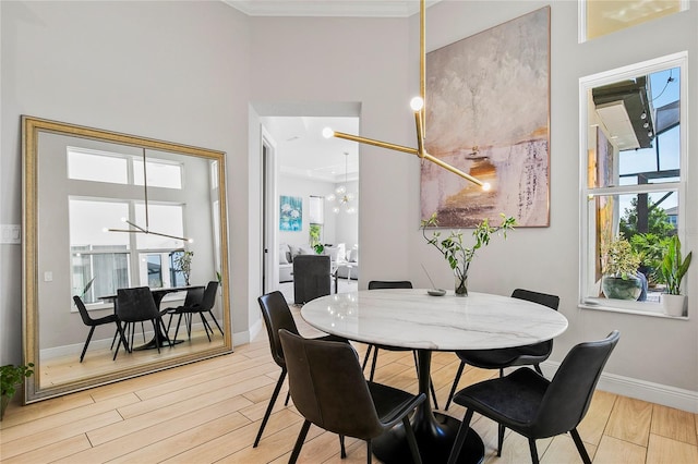 4754 Manning Ct, Sarasota, FL 34240 - dining room featuring a chandelier, baseboards, light wood-style floors, and ornamental molding