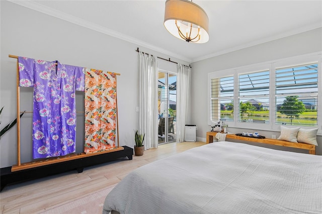 4754 Manning Ct, Sarasota, FL 34240 - bedroom featuring access to exterior, wood finished floors, ornamental molding, and baseboards