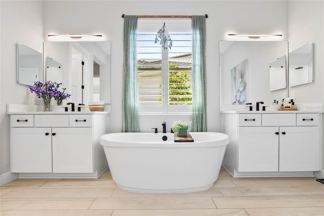 4754 Manning Ct, Sarasota, FL 34240 - bathroom with two vanities, a soaking tub, and wood finished floors