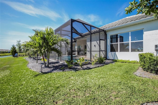 4754 Manning Ct, Sarasota, FL 34240 - back of house with stucco siding, a lawn, glass enclosure, a pool, and a tiled roof