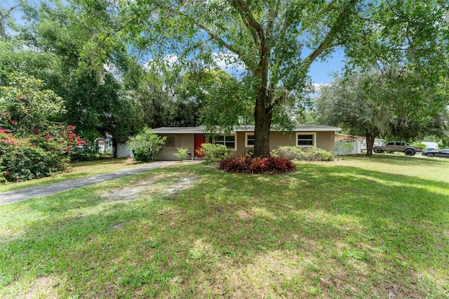 17 S Aurora Dr, Apopka, FL 32703 - ranch-style house with asphalt driveway, a front lawn, an attached carport, and stucco siding