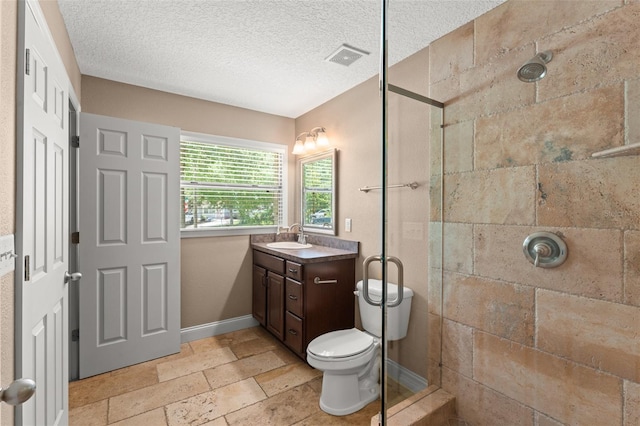 17 S Aurora Dr, Apopka, FL 32703 - bathroom with vanity, tiled shower, toilet, a textured ceiling, and baseboards