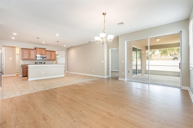 11621 Ashton Field Ave, Riverview, FL 33579 - unfurnished living room with a chandelier, light wood-style floors, recessed lighting, and baseboards