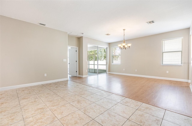 11621 Ashton Field Ave, Riverview, FL 33579 - spare room featuring a chandelier, light tile patterned floors, and baseboards