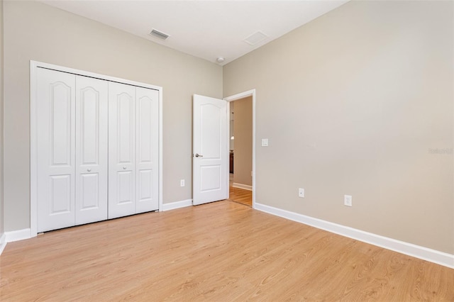 11621 Ashton Field Ave, Riverview, FL 33579 - unfurnished bedroom featuring light wood finished floors, baseboards, and a closet