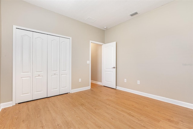 11621 Ashton Field Ave, Riverview, FL 33579 - unfurnished bedroom featuring light wood finished floors, baseboards, and a closet