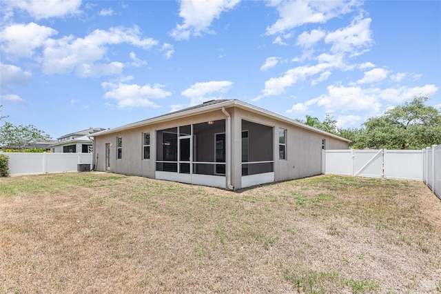 11621 Ashton Field Ave, Riverview, FL 33579 - rear view of property with a gate, central AC, a sunroom, and stucco siding