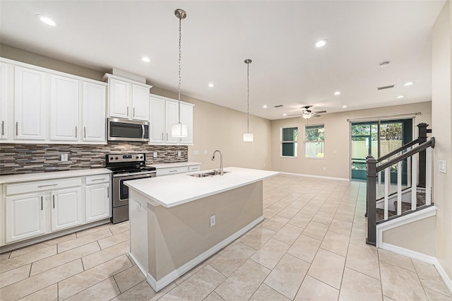 6703 Citrus Creek Ln, Tampa, FL 33625 - kitchen with appliances with stainless steel finishes, a sink, decorative backsplash, a ceiling fan, and light tile patterned floors