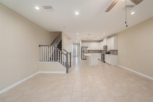 6703 Citrus Creek Ln, Tampa, FL 33625 - kitchen featuring appliances with stainless steel finishes, a sink, open floor plan, an island with sink, and tasteful backsplash
