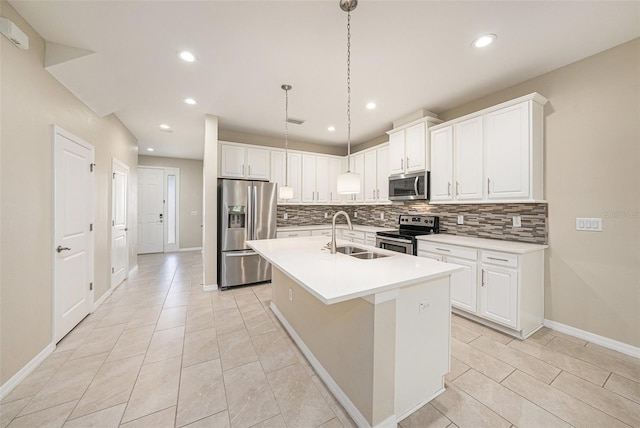 6703 Citrus Creek Ln, Tampa, FL 33625 - kitchen featuring appliances with stainless steel finishes, a sink, tasteful backsplash, baseboards, and a kitchen island with sink