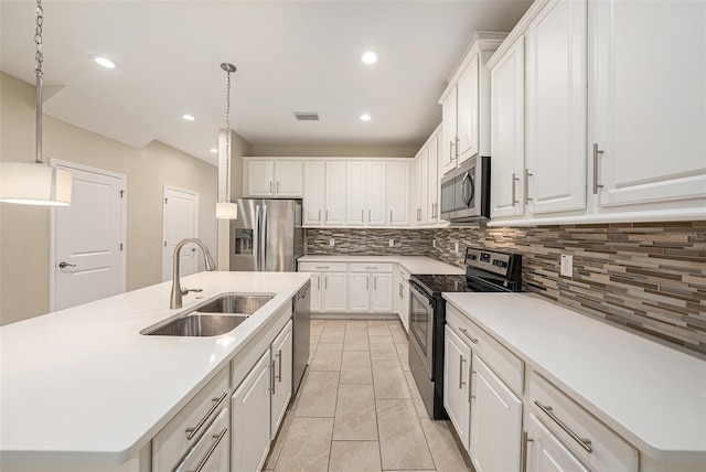6703 Citrus Creek Ln, Tampa, FL 33625 - kitchen featuring stainless steel appliances, a sink, tasteful backsplash, hanging light fixtures, and white cabinets