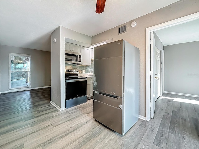 6100 12th St S Unit 313, Saint Petersburg, FL 33705 - kitchen with stainless steel appliances, light wood finished floors, a ceiling fan, and baseboards