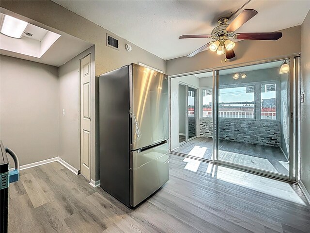 6100 12th St S Unit 313, Saint Petersburg, FL 33705 - kitchen featuring freestanding refrigerator, light wood-style flooring, ceiling fan, and baseboards
