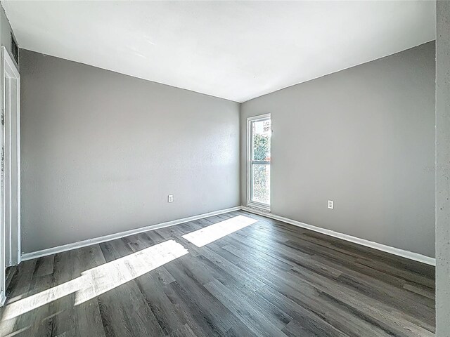 6100 12th St S Unit 313, Saint Petersburg, FL 33705 - spare room with dark wood-style flooring and baseboards