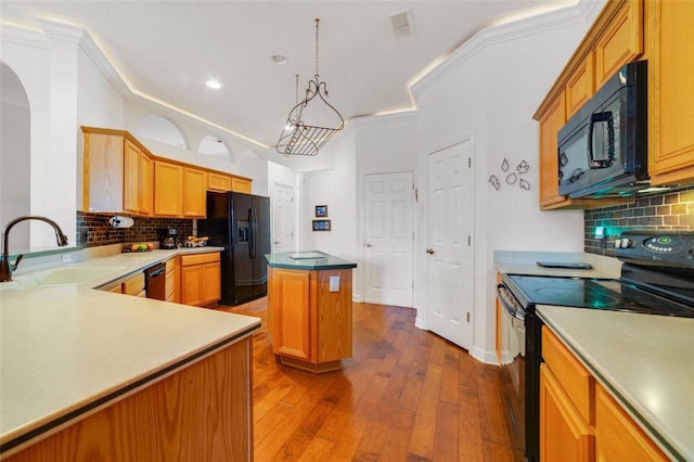 1515 Cherry Lake Way, Lake Mary, FL 32746 - kitchen featuring black appliances, a sink, a center island, hardwood / wood-style floors, and backsplash