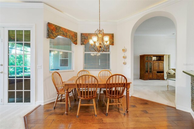 1515 Cherry Lake Way, Lake Mary, FL 32746 - dining room with hardwood / wood-style floors, arched walkways, a chandelier, crown molding, and baseboards