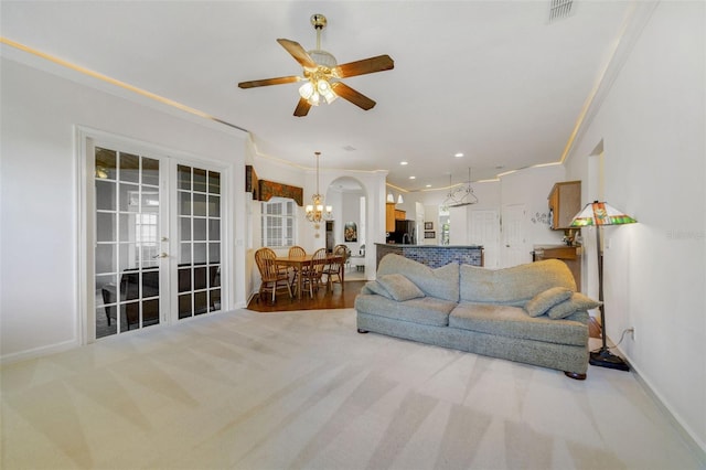 1515 Cherry Lake Way, Lake Mary, FL 32746 - living room featuring a chandelier, baseboards, carpet, ceiling fan, and crown molding