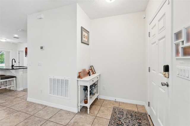15411 Taurus Ct, Mascotte, FL 34753 - entryway with light tile patterned floors and baseboards
