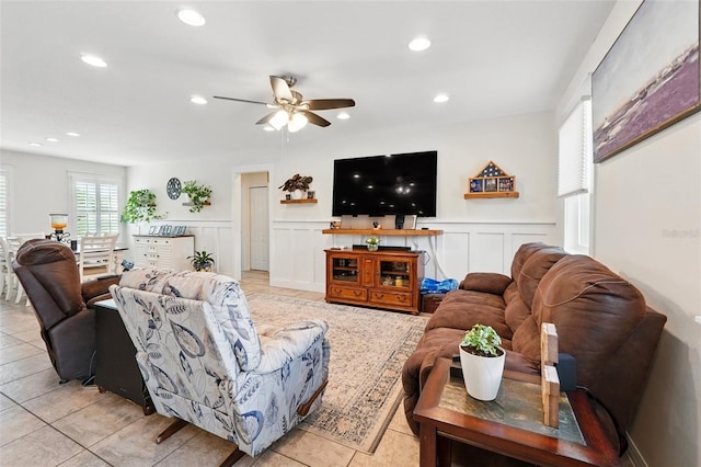 15411 Taurus Ct, Mascotte, FL 34753 - living room with ceiling fan, a wainscoted wall, a decorative wall, recessed lighting, and light tile patterned floors