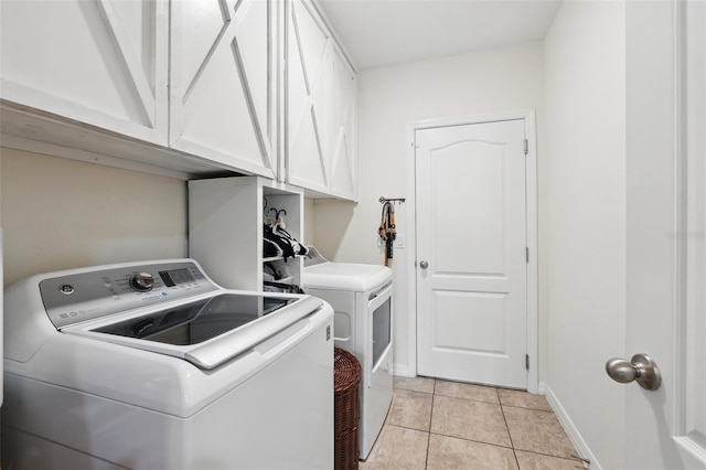 15411 Taurus Ct, Mascotte, FL 34753 - laundry room featuring cabinet space, washing machine and dryer, baseboards, and light tile patterned floors