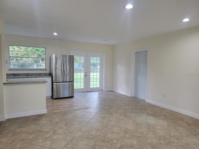 1107 Greenwood Way, Cocoa, FL 32922 - spare room with healthy amount of natural light, french doors, recessed lighting, light tile patterned floors, and baseboards