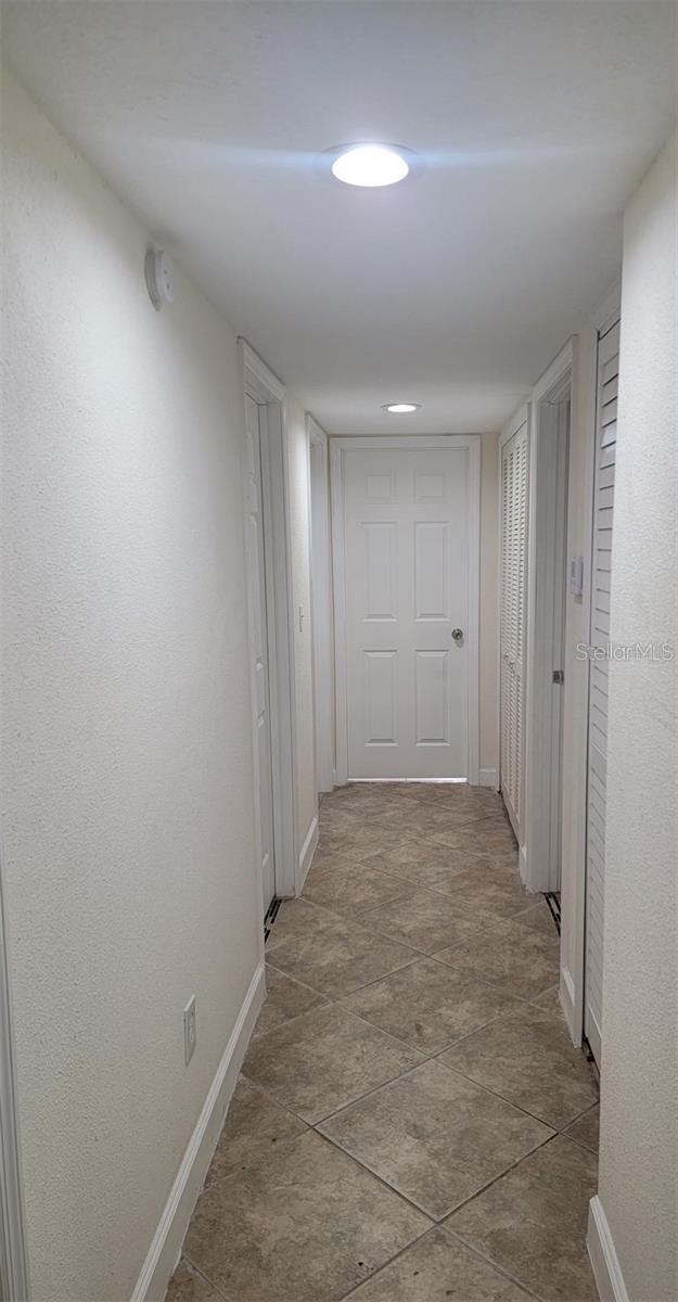 1107 Greenwood Way, Cocoa, FL 32922 - corridor featuring baseboards