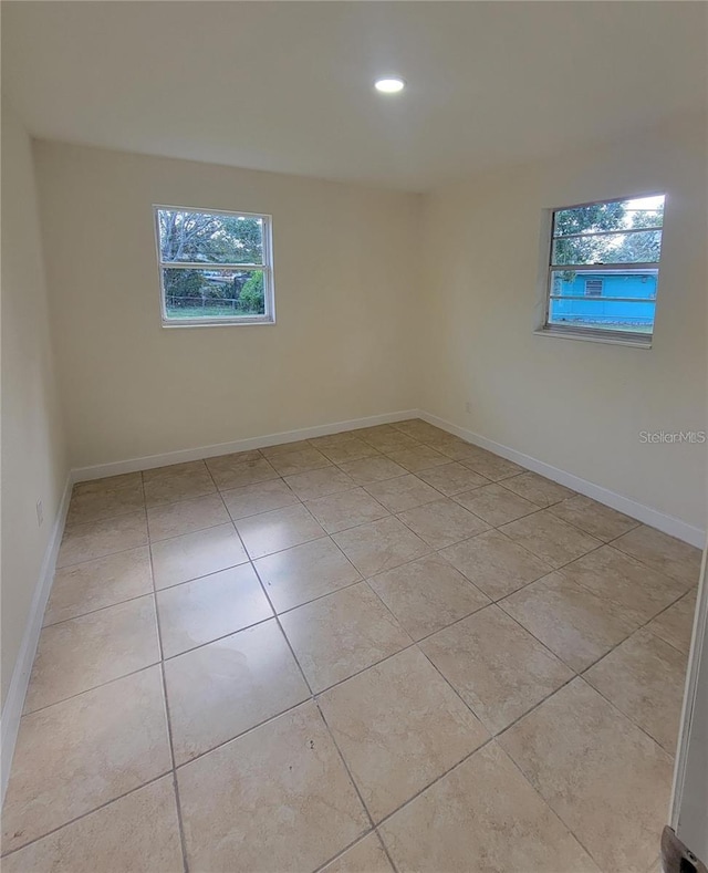 1107 Greenwood Way, Cocoa, FL 32922 - spare room with healthy amount of natural light, light tile patterned floors, recessed lighting, and baseboards
